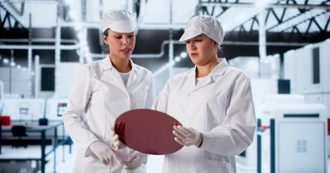 Engineer In Semiconductor Factory Checks Chip Samples For Research Project. Stock Photos