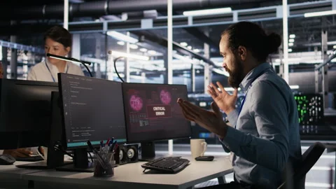 Engineer in server hub dealing with unexpected system error alert Stock Footage 309641643