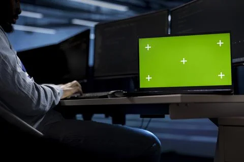 Engineer in server hub using chroma key PC to repair equipment storing datasets 스톡 사진