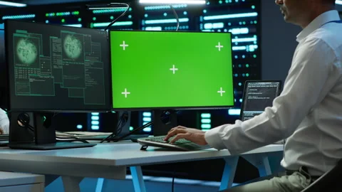 Engineer in server hub using green screen PC to stop hacker Stock Footage 280804639