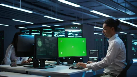 Engineer in server hub using green screen PC to stop hacker Stock Footage 280805392