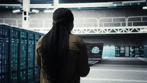 Engineer in server hub using laptop to upgrade rigs using AI deep learning Stock Footage 317203883