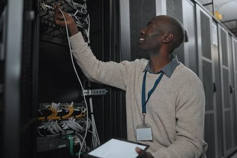 Engineer, server room and black man with cable and tablet for database Stock Photos