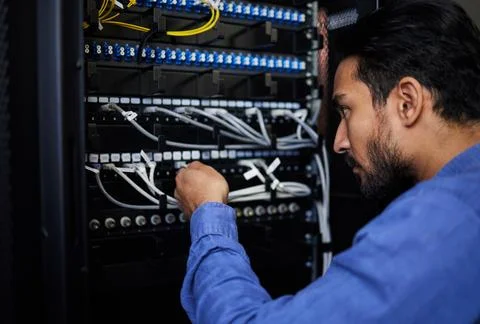 Engineer, server room and man with cable connection for software update or Stock Photos