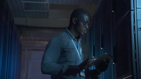 Engineer serves present data center black guy with tablet Stock Footage 163814160