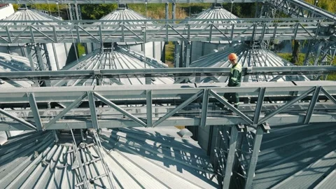 Engineer servicing and inspecting large grain storage containers. An employee of Stock Footage 158304004