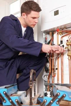 Engineer Servicing Central Heating Boiler Stock Photos
