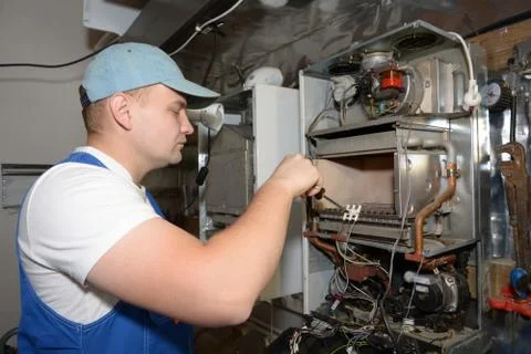 Engineer Servicing Central Heating Boiler Stock Photos
