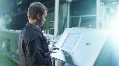 Engineer is Setting Up CNC Lathe Machine in Factory Stock Footage 47914376
