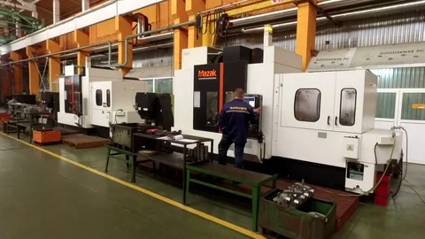 Engineer setting up a computer-integrated manufacturing machine Stock Footage 71023981