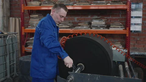 An engineer setting up the equipment for fabric processing at the plant Stock Footage 243100723