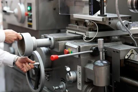 Engineer setting up metalworking lathe Stock Photos