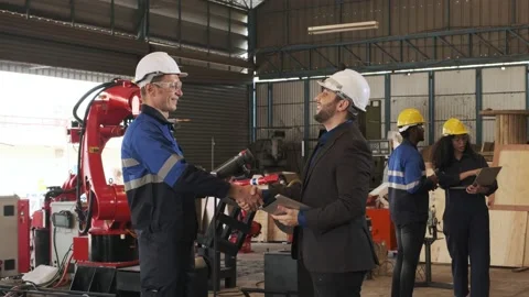 Engineer shake hands with factory manager about industrial robot arm. Stock Footage 233180554