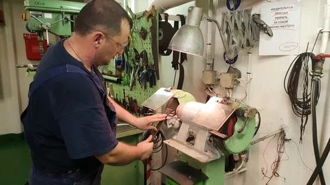 Engineer sharpens detail on grinding machine on tanker Stock Footage 121118534