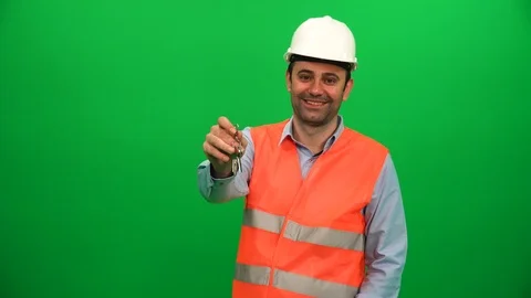 Engineer Showing Keys in front of Green Screen Stock Footage 88656579