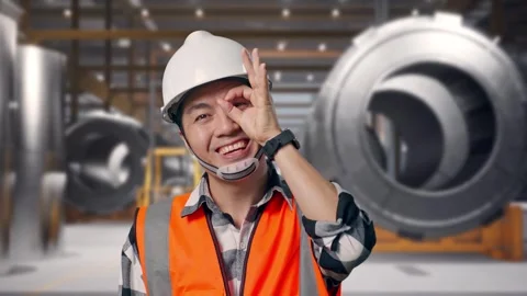 Engineer Showing Ok Hand Sign Over Eye And Smiling at Heavy Factory Stock Footage 340819429