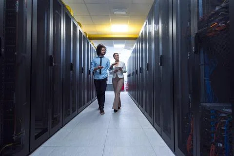 Engineer showing working data center server room to female chief Young IT ... Foto stock
