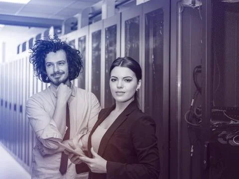 Engineer showing working data center server room to female chief Young IT ... Foto stock