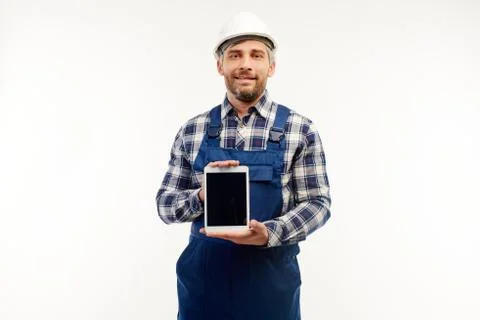 Engineer shows tablet to the camera on a white background. Stock Photos