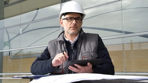 Engineer on site checking project on digital tablet Stock Footage 86617268