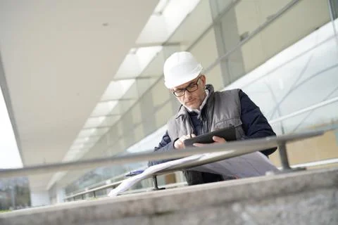 Engineer on site checking project on digital tablet Stock Photos