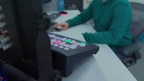 An engineer sits down and start typing on a keyboard Stock Footage 274176584