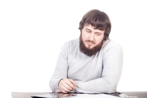 Engineer, sits at the table, thinking about the project budget Stockfoto's