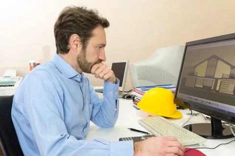 Engineer sitting in front of the computer in his office Stock Photos