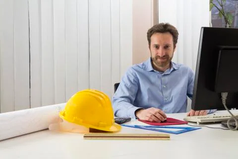 Engineer sitting in front of the computer in his office Stock Photos