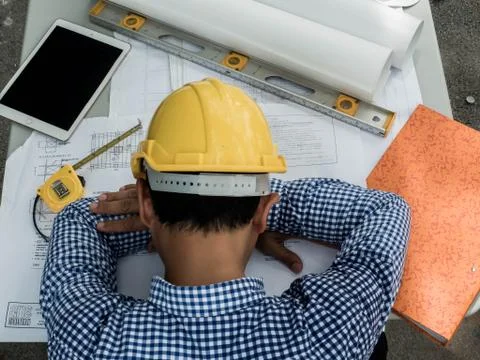 Engineer sleeps on the table while working. Stock Photos