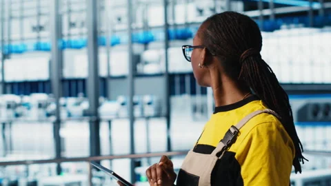 Engineer in smart factory implementing automated workflows Stock Footage 305490517
