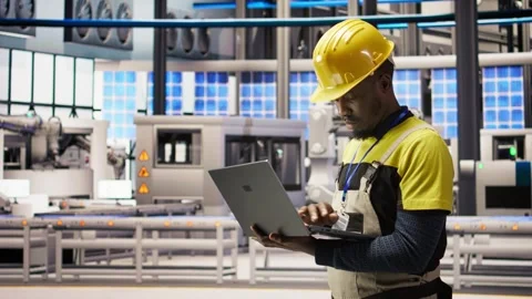 Engineer in smart factory implementing renewable energy solutions Stock Footage 308727094