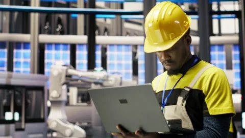 Engineer in smart factory implementing renewable energy solutions Stock Footage 308727431