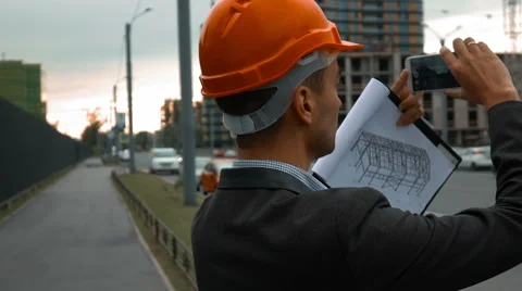 Engineer with the smart phone taking pictures of construction Stock Footage 65374445