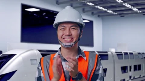 Engineer Smiling And Clapping His Hands With Train in Lab Video stock 314113215