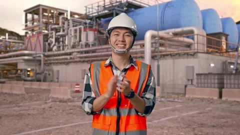Engineer Smiling And Clapping His Hands at Gas Plant Stock Footage 337761401