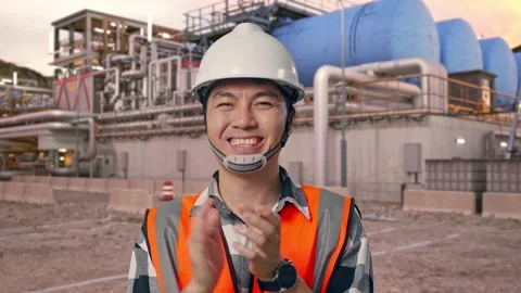 Engineer Smiling And Clapping His Hands at Gas Plant Stock Footage 337761418