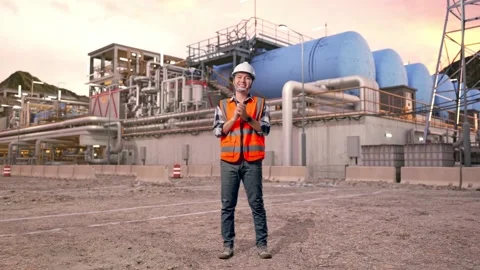 Engineer Smiling And Clapping His Hands at Gas Plant Stock Footage 337761940