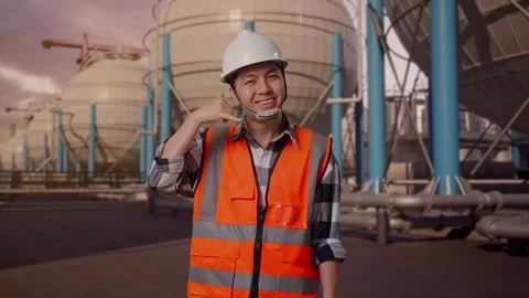 Engineer Smiling And Making Call Me Gesture with Spherical Tank Stock Footage 335066181