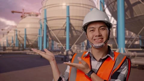 Engineer Smiling And Pointing To Side with Spherical Tank Stock Footage 335067249