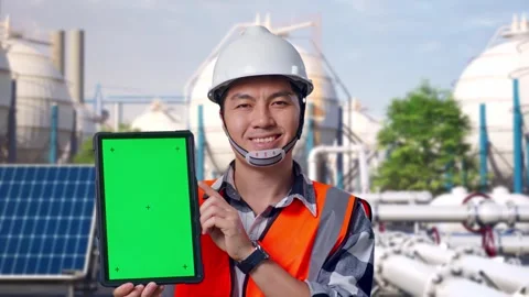 Engineer Smiling And Showing Green Screen Tablet at Energy Complex Stock Footage 330181280