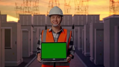 Engineer Smiling And Showing Green Screen Laptop with High Voltage Power Stock Footage 331194970