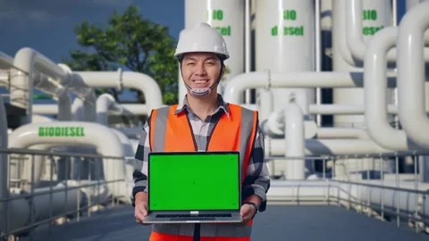 Engineer Smiling And Showing Green Screen Laptop at Biodiesel plant Stock Footage 332090067