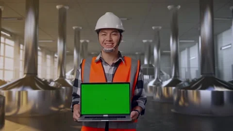 Engineer Smiling And Showing Green Screen Laptop at Beer Plant Stock Footage 332544551