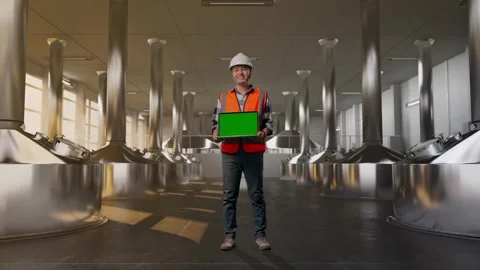 Engineer Smiling And Showing Green Screen Laptop at Beer Plant Stock Footage 332545935
