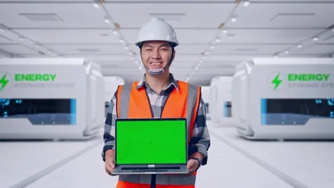 Engineer Smiling And Showing Green Screen Laptop at Power Plant Stock Footage 333771606