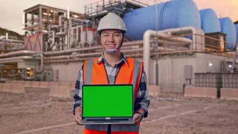 Engineer Smiling And Showing Green Screen Laptop at Gas Plant Stock Footage 337760824