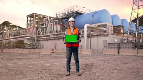 Engineer Smiling And Showing Green Screen Laptop at Gas Plant Stock Footage 337762097