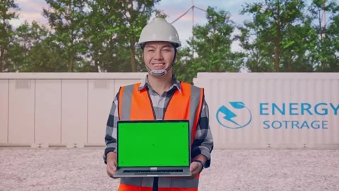 Engineer Smiling And Showing Green Screen Laptop with Energy Storage Stock Footage 337816569