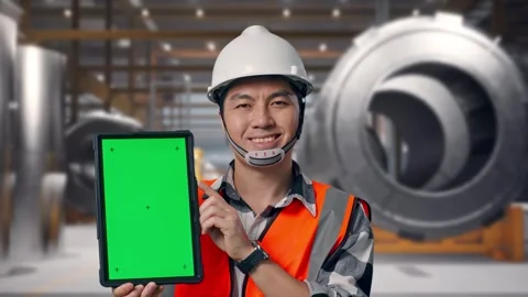 Engineer Smiling And Showing Green Screen Tablet at Heavy Factory Stock Footage 340818739